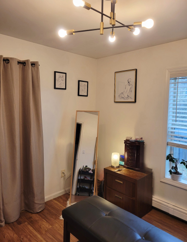 Master closet with dressing station, lux leather ottoman, gold framed mirror, and jewelry storage